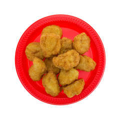 Chicken nuggets on a small red plate