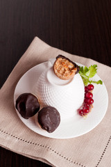 Homemade natural chocolates with marzipan on black background