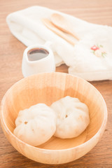 Steamed dumpling stuff on wooden bowl
