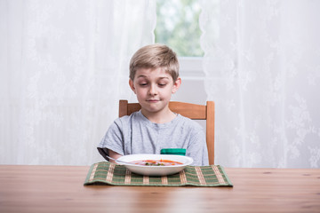 Boy with tomato soup