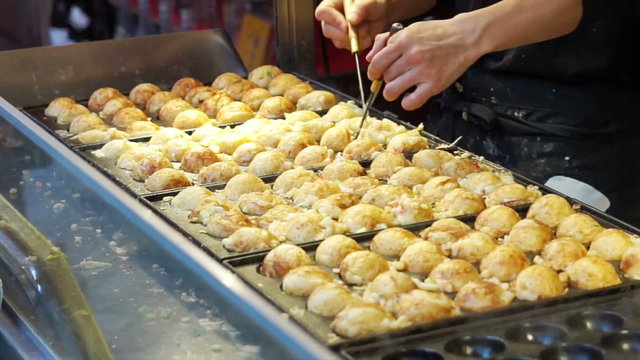 Cooking takoyaki Japanese octopus flour ball. Traditional Japan snack cuisine