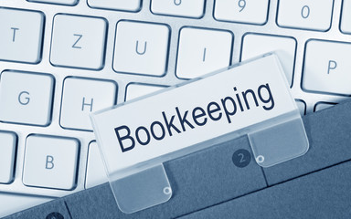 Bookkeeping - folder on keyboard in the office
