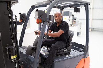 Portrait Of Male Fork Lift Truck Driver In Factory