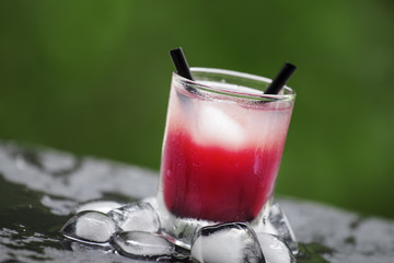 Frozen pink cocktail with ice on the sun deck on a summer day, s