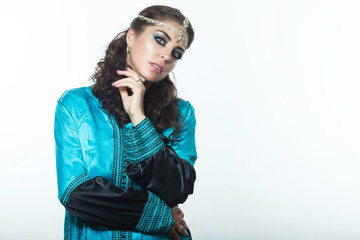 Beautiful girl in the Arab image with bright oriental makeup.