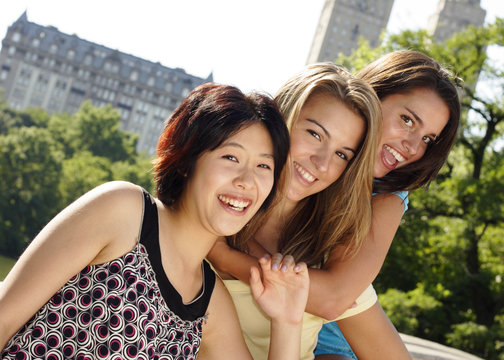 Three friends two piggyback having enormus fun!