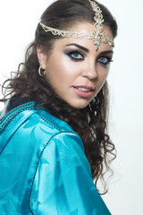 Beautiful girl in the Arab image with bright oriental makeup.