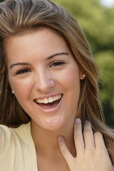 Happy young woman laughing.