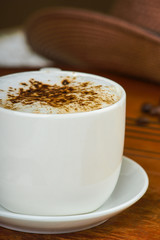 Fresh cappuccino coffee cup and guitar