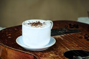 Coffee cup, coffee beans and guitar
