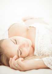 Fototapeta na wymiar Pregnant woman lying on the bed