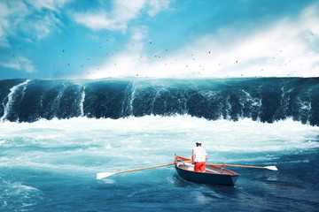 Man on a boat facing tsunami - obrazy, fototapety, plakaty