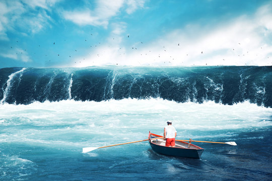 Fototapeta Man on a boat facing tsunami