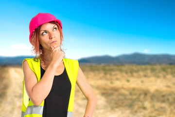 Worker woman thinking over isolated white background