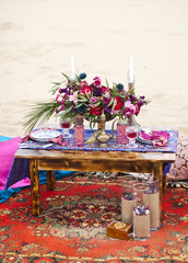 Wedding table arrangement in desert sand of Morocco stile