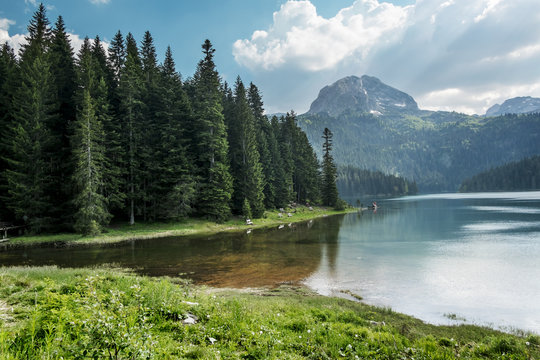 Black lake in the national park Durmitor and mountains in the ba