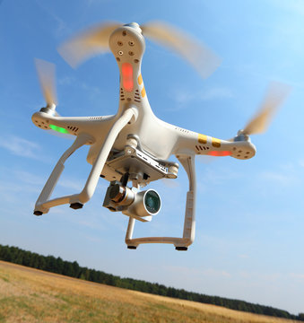 Drone quadrocopter with high resolution digital camera. New tool for aerial photo and video.
