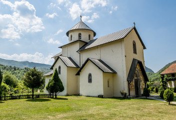 Monastery on the river Moraca amid mountains in the background.