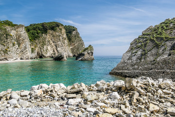 Fototapeta na wymiar The beach and the cliffs on the island of St. Nicholas in Budva,