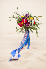 Beautiful wedding bouquet in the desert sand