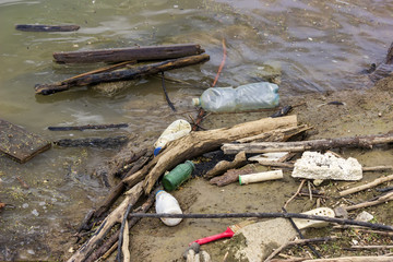 Obraz premium Plastic bottles and garbage waste on the shore 3