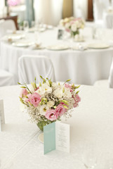 Menu card with beautiful flowers on table in wedding day