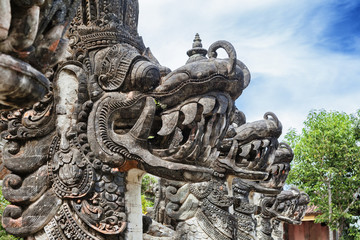 Traditional indonesian art and symbol of balinese hindu religion - faces of mythological dragons in front of Lempuyang temple entrance. Bali people culture and asian travel backgrounds.
