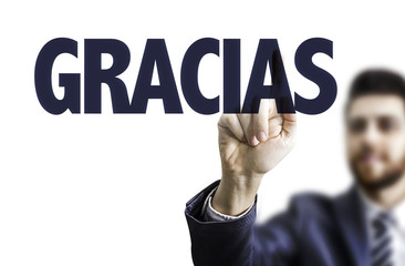 Business man pointing the text: Thank You (in Spanish)