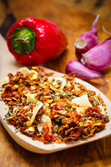 Colored spices for pasta mix on wooden spoon