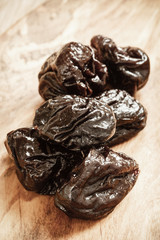 dried plums prunes on wooden table