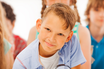 Clever looking boy in the group of kids