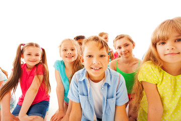 Bunch of attentive kids sitting and smiling