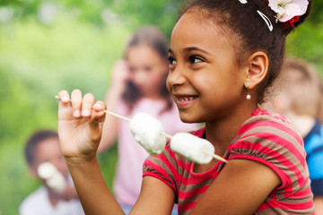 Portrait of African girl and marshmallow stick