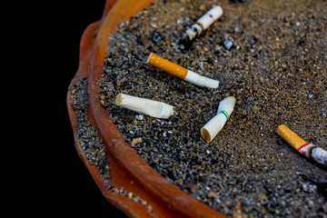 smoked cigarettes in a dirty ashtray