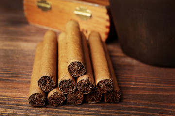 Cigars on wooden table, closeup
