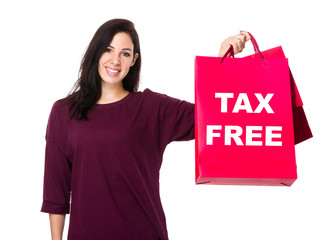 Woman hold with shopping bag and showing tax free