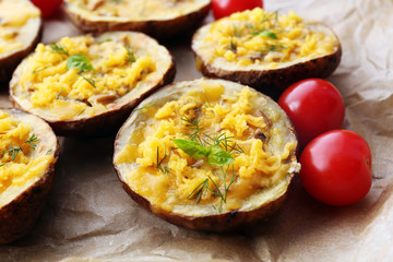 Baked potatoes with cheese and mushrooms on table close up