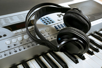 Headphones on synthesizer close up