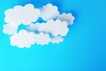 White paper clouds on blue background. Cloud computing concept.