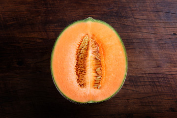 Organic cantaloupe on wooden table