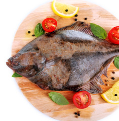 Fresh fish with spices on cutting board isolated on white