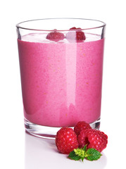 Glass of raspberry milk shake on light background