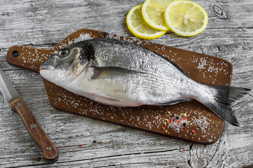 fresh Dorado fish on light wooden background