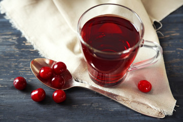 Sweet homemade cherry juice on table, on light background