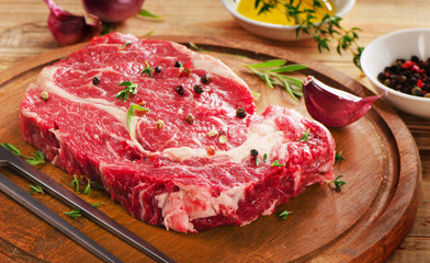 Raw Beef Steak on  wooden  table.