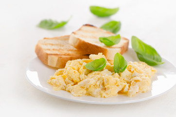 Breakfast with scrambled eggs and toasts.