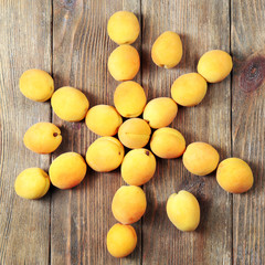 Ripe apricots on wooden background