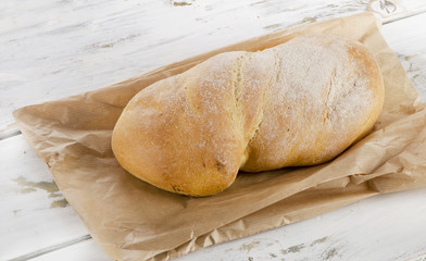 Italian bread ciabatta on wooden table.