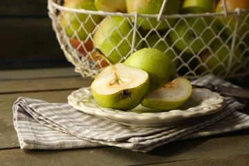Ripe tasty pears in basket on table close up