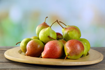 Ripe tasty pears on bright background